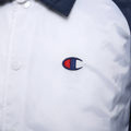 Daily Deals Outlet Champion coach jacket in white with blue collar and embroidered red, white, and blue logo detail.