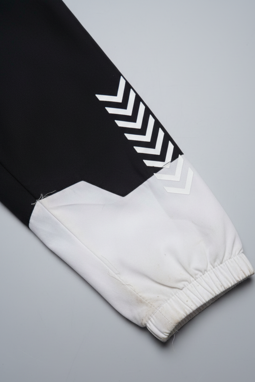 Daily Deals Outlet Hummel men's jacket sleeve in black and white with signature chevron branding and elastic cuff