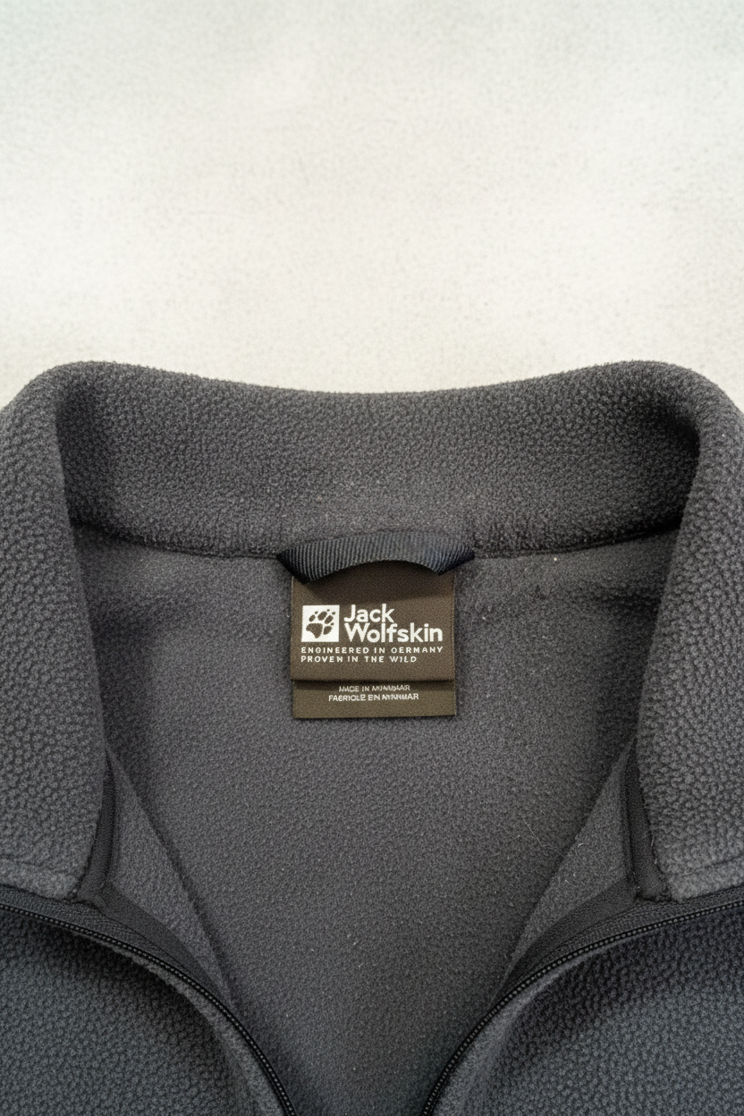Daily Deals Outlet blue Jack Wolfskin fleece jacket collar with brand logo label and polyester texture