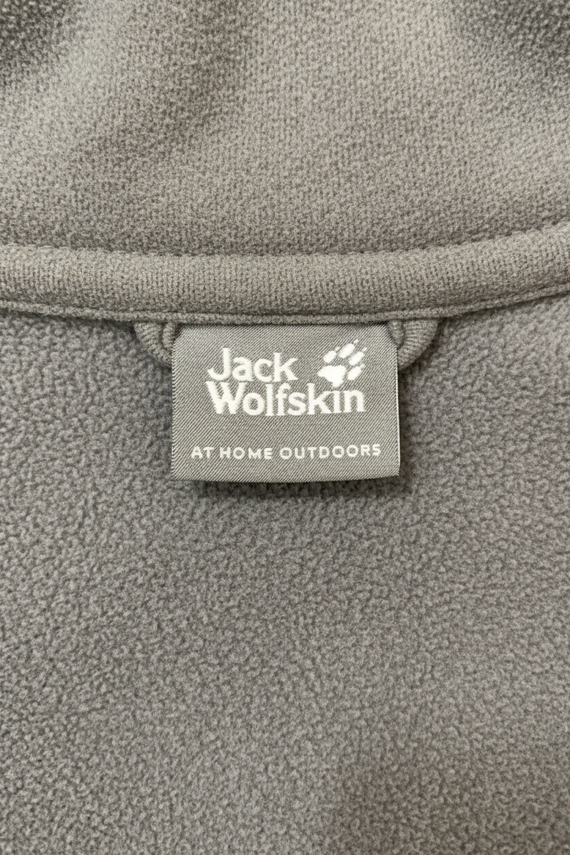 Daily Deals Outlet Jack Wolfskin fleece jacket brand label on grey polyester fabric