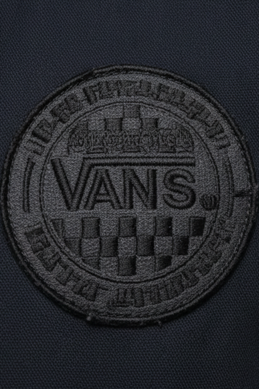 Daily Deals Outlet Vans blue cotton bomber jacket featuring a circular embroidered brand logo patch on the fabric.